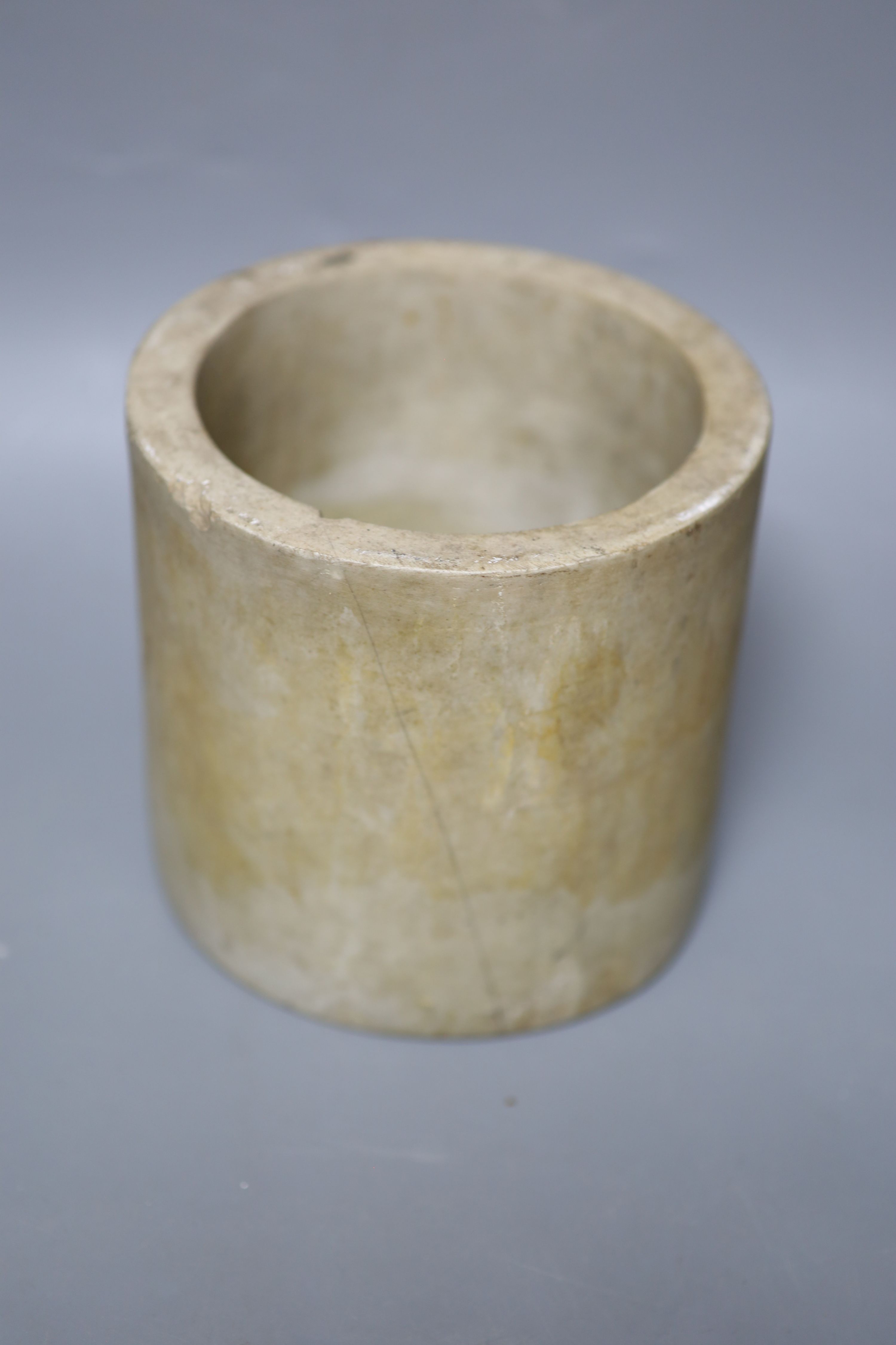 A Chinese blue and white Ming porcelain finial, a leather wallet. c.1920 and a cream stone cylinder, longest 29cm